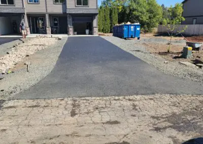 New townhouse driveway paving with dumpster and landscaping rubble